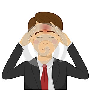 Young businessman with headache holding his head on his temples