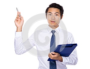 Young businessman hold with clipboard and pen point up