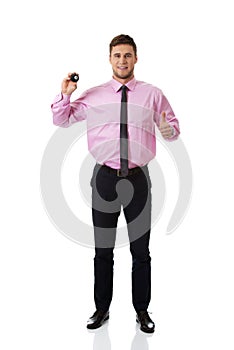 Young businessman holding billiard ball.
