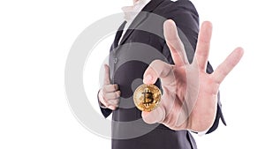 Young businessman holding bitcoin on hand. Isolated on white.