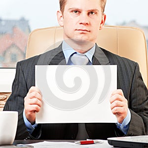 Young businessman holding blank