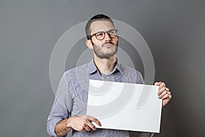 Young businessman holding a blank banner with imagination