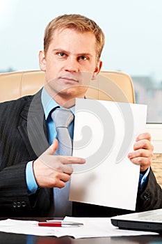 Young businessman holding blank pape