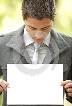 Young businessman holding a blank sign photo