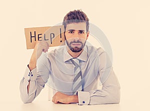 Young Businessman Holding Cardboard With Help Text At Workplace in stress and pressure at work