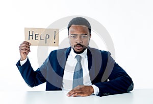 Young Businessman Holding Cardboard With Help Text At Workplace in stress and pressure at work