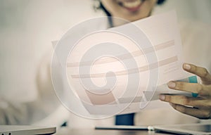 Young businessman holding and looking at document paper