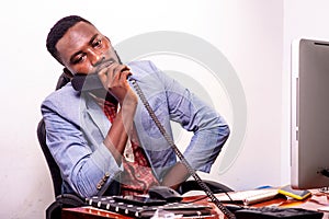 Young businessman holding a phone in the office