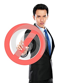 Young businessman holding prohibited sign