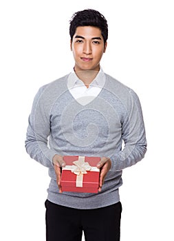 Young businessman holding with red gift box