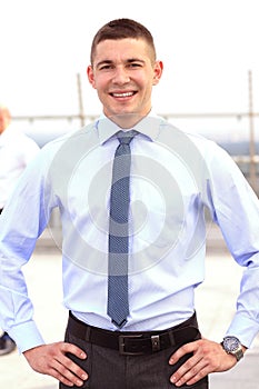 Young businessman holding tablet in hands outdoor