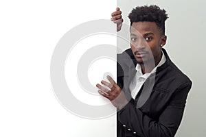 Young businessman holding white panel presenting display page