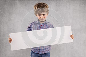 Young businessman holds an advertising space for sale, sed face photo