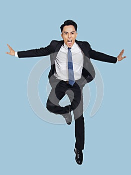 Young  businessman jumping in air