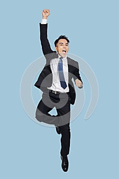 Young  businessman jumping in air