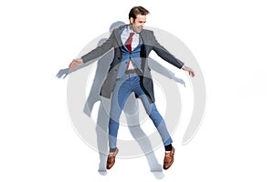 Young businessman jumping high in the sky