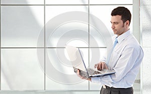 Young businessman with laptop