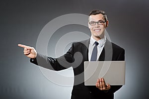 The young businessman with laptop in business concept