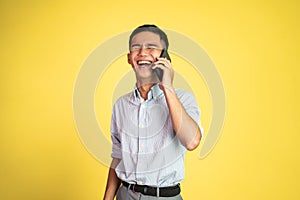 young businessman laughing while making phone call