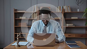 Young businessman or lawyer working with laptop and sitting at table in corporate office spbas.