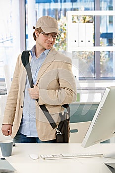 Young businessman leaving office