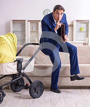 Young businessman looking after baby
