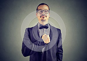 Overconfident man posing on gray photo