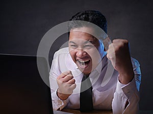 Young Businessman Looking at Laptop, Winning Gesture
