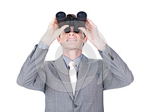 Young businessman looking up through binoculars