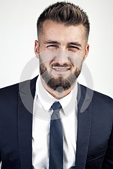 Young businessman looks doubtfully into the camera