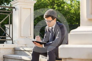 Young businessman making notes