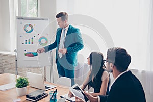 Young businessman making presentation and showing diagrama on whiteboard photo