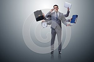 The young businessman in multitasking concept