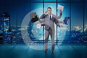 The young businessman in multitasking concept