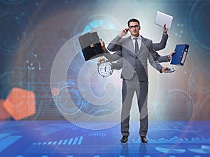 The young businessman in multitasking concept