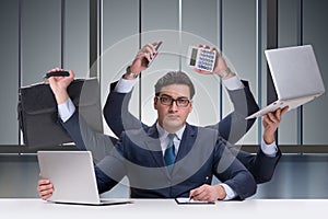 The young businessman in multitasking concept
