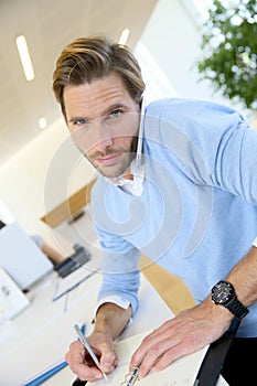 Young businessman negotiating on phone