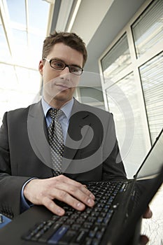 Young businessman office space smile laptop