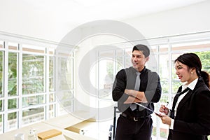 Young businessman in office. Two business professionals working together. Man and woman attractive looking.