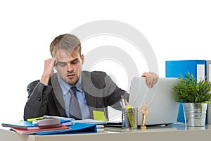 Young businessman overworked looking worried sitting at office computer desk in stress