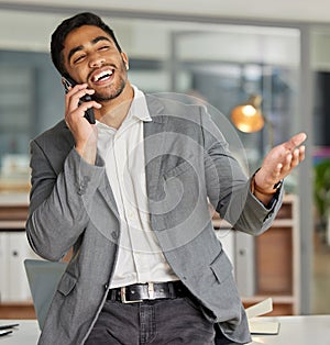 Young businessman, phone call and happy in office for chat, laugh and communication at desk. Male consultant, networking