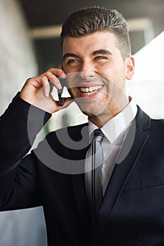 Young businessman on the phone in an office building