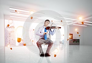 young businessman playing violin