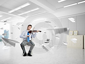 young businessman playing violin