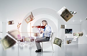 young businessman playing violin