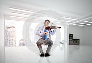 young businessman playing violin