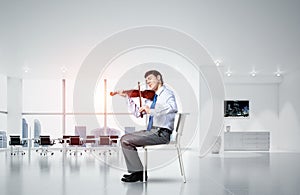 young businessman playing violin