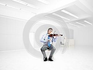 young businessman playing violin