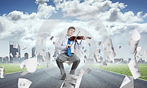 young businessman playing violin