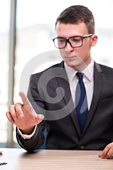 The young businessman pressing buttons in business concept